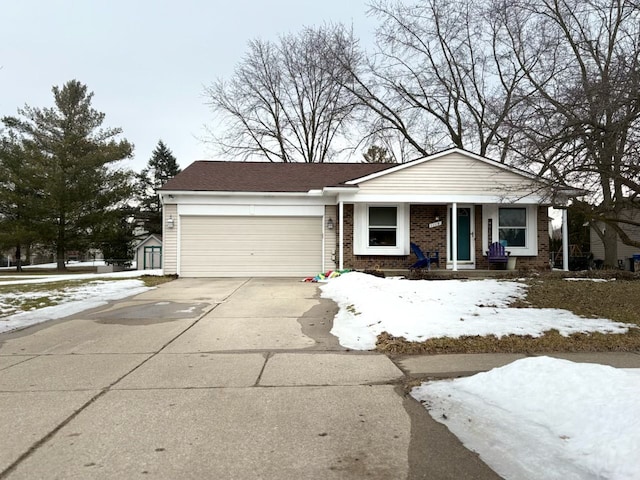 view of front of house featuring driveway, a garage, and brick siding