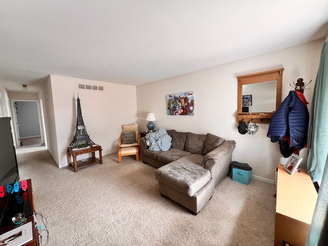 carpeted living area with baseboards and visible vents