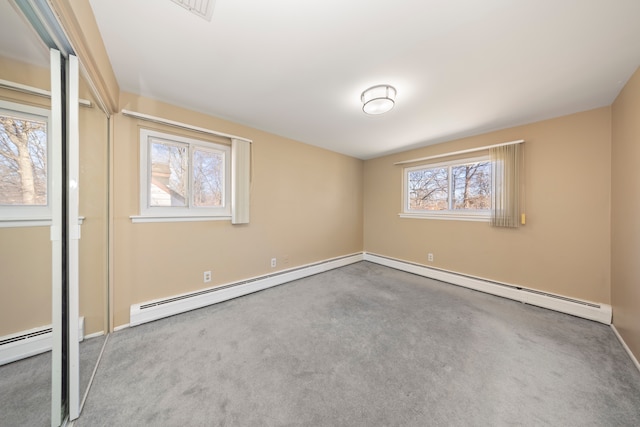 unfurnished bedroom featuring carpet and a baseboard radiator