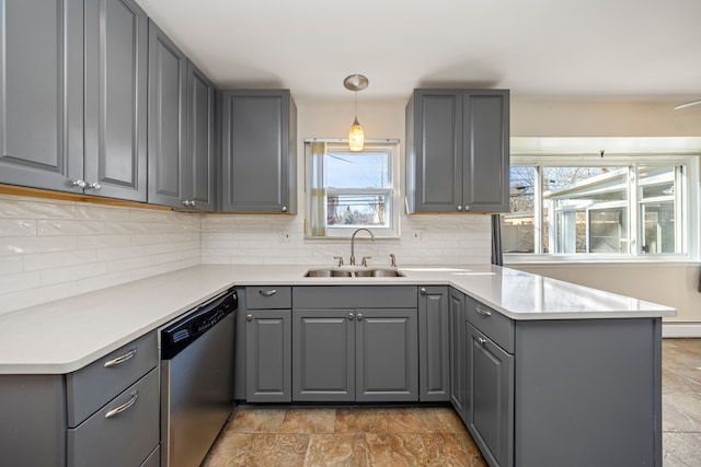 kitchen featuring gray cabinets, stainless steel dishwasher, and a sink