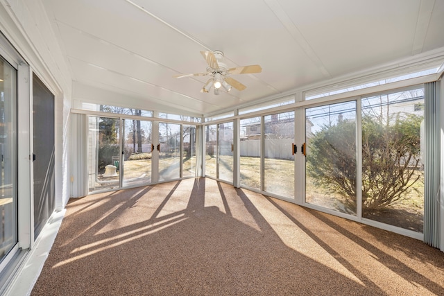 unfurnished sunroom with a wealth of natural light, lofted ceiling, and ceiling fan