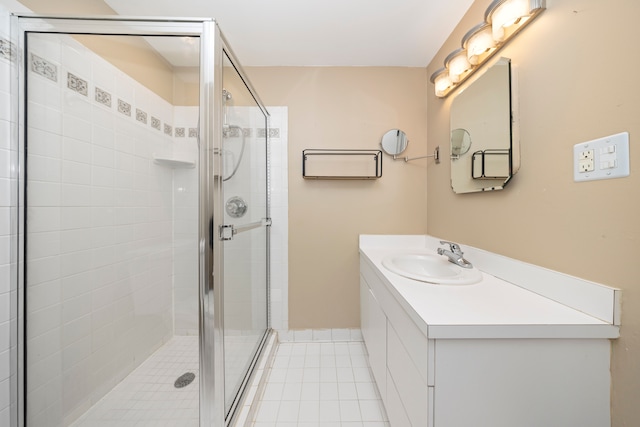 full bathroom with tile patterned floors, vanity, and a shower stall