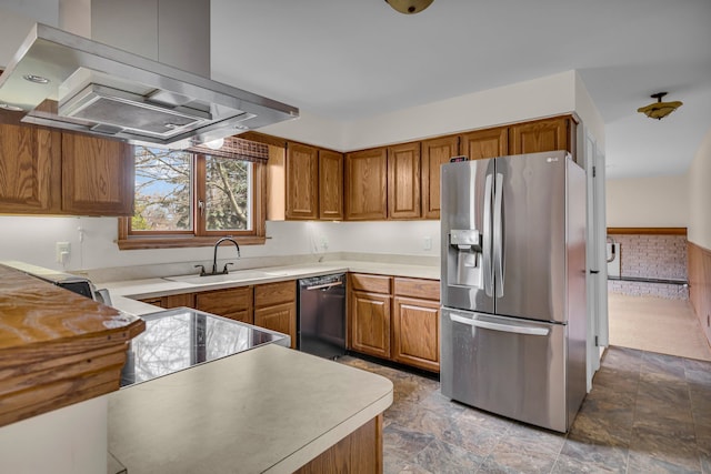 kitchen featuring black dishwasher, stainless steel fridge, brown cabinets, island exhaust hood, and a sink