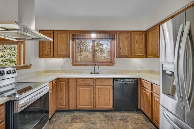 kitchen with stainless steel appliances, brown cabinets, a sink, and exhaust hood