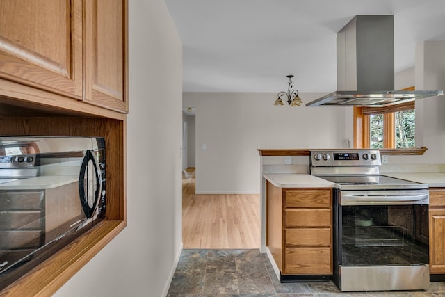 kitchen with baseboards, stainless steel electric range oven, island exhaust hood, light countertops, and black microwave