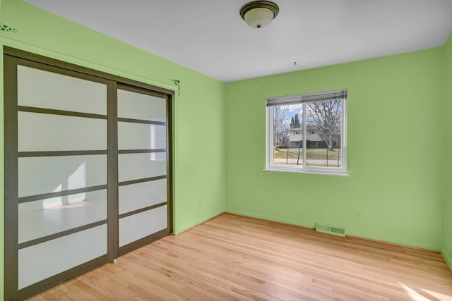 empty room with visible vents and light wood-style floors