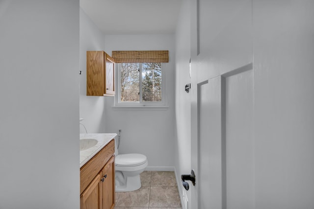 bathroom featuring tile patterned flooring, baseboards, vanity, and toilet