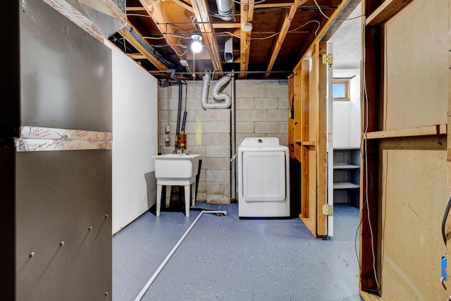 unfinished basement with washer / clothes dryer and a sink