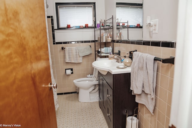 5324 Buchanan Ave, Warren, MI 48092 - bathroom with tile walls, toilet, wainscoting, vanity, and tile patterned flooring