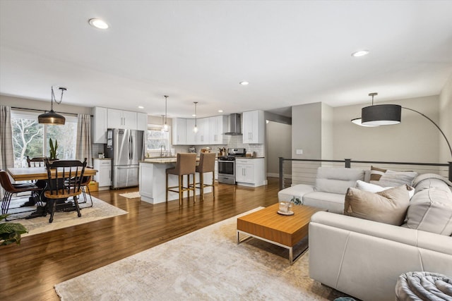 living room with baseboards, dark wood-style flooring, and recessed lighting