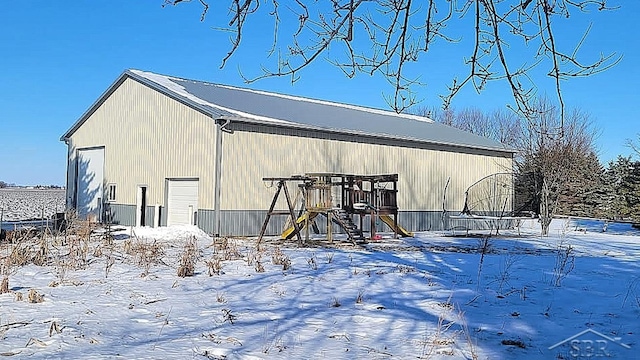 exterior space featuring an outbuilding, a pole building, and a detached garage