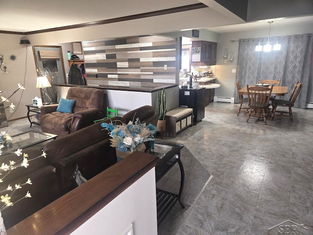 living area with a baseboard heating unit, ornamental molding, and a chandelier