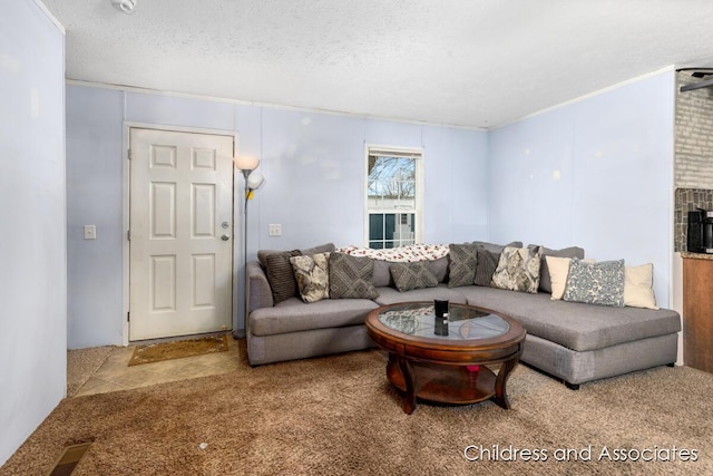 carpeted living area featuring a textured ceiling, a fireplace, and visible vents