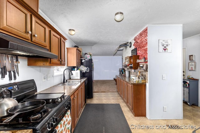 kitchen featuring brown cabinets, under cabinet range hood, a textured ceiling, black appliances, and a sink