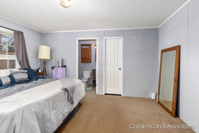 bedroom with carpet flooring, crown molding, a textured ceiling, and ensuite bathroom