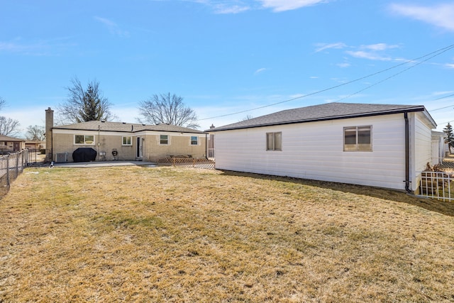 rear view of property featuring a patio area, a fenced backyard, and a yard