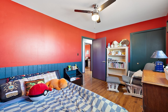 bedroom with wood finished floors and a ceiling fan