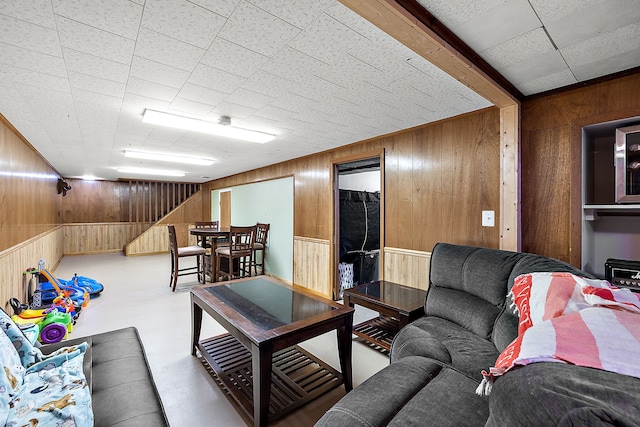 living area featuring concrete floors and wood walls