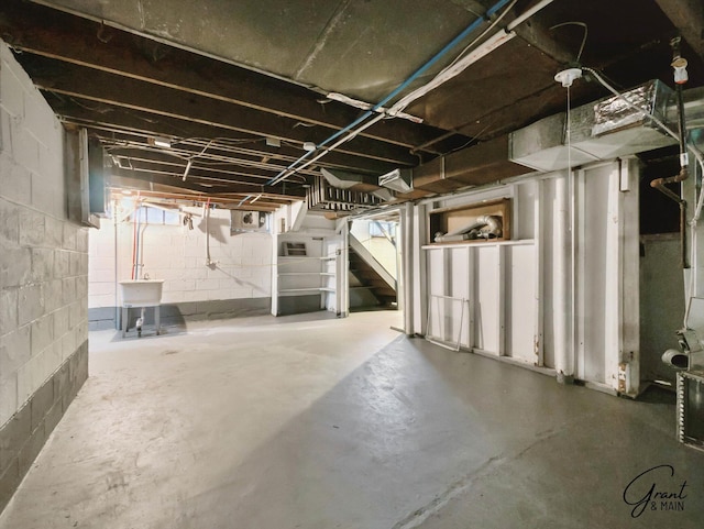 unfinished basement with stairs and a sink