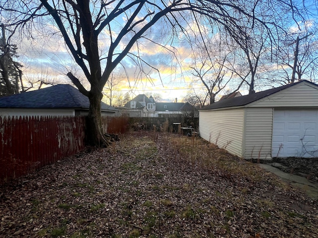 view of yard featuring fence and an outdoor structure