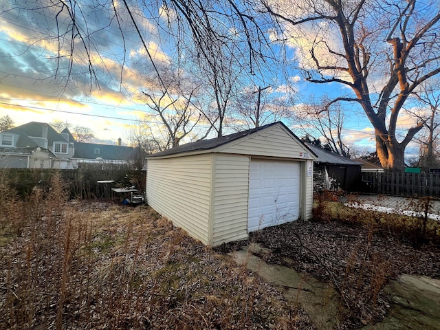 detached garage featuring fence