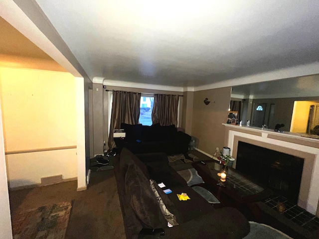 living room featuring a fireplace, carpet flooring, and baseboards