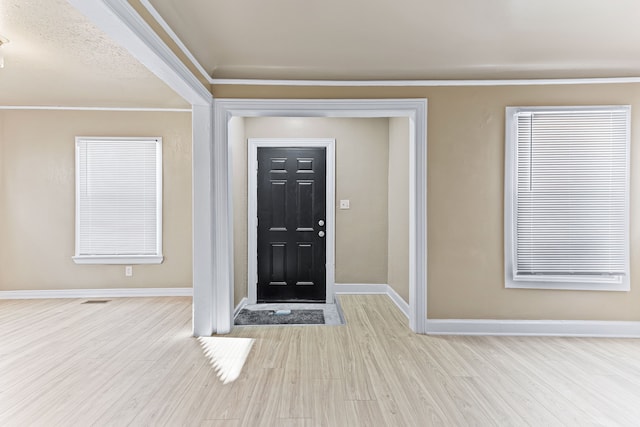 entryway featuring baseboards and wood finished floors