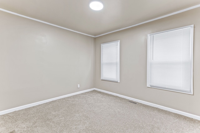 carpeted empty room with visible vents and baseboards