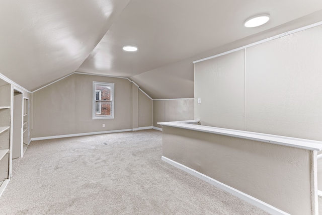 bonus room featuring vaulted ceiling, carpet, and baseboards