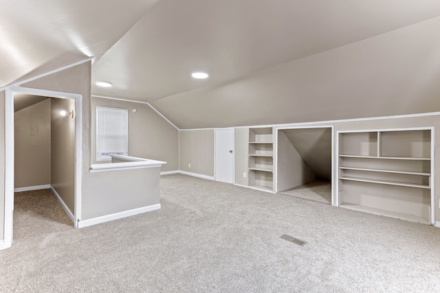 bonus room featuring carpet, visible vents, lofted ceiling, and baseboards