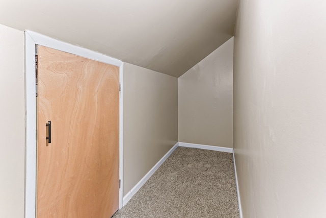 additional living space with carpet floors, lofted ceiling, and baseboards