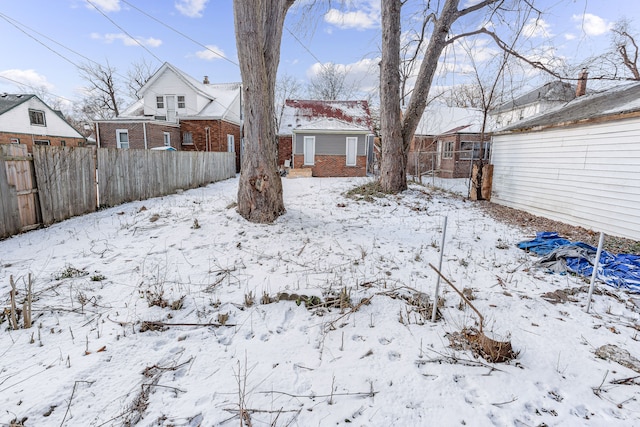 snowy yard with fence