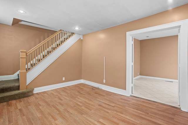 interior space with stairway, recessed lighting, wood finished floors, and baseboards