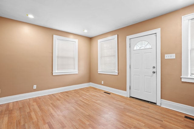 foyer with visible vents, light wood-type flooring, and baseboards