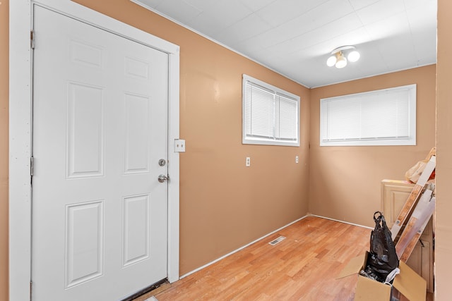 foyer featuring light wood-type flooring and visible vents