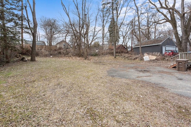 view of yard with an outdoor structure and fence