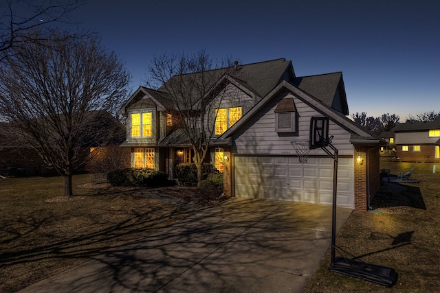 traditional-style house featuring brick siding, concrete driveway, and an attached garage