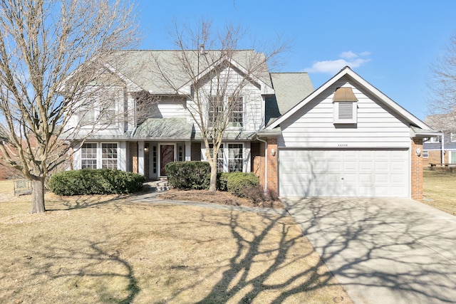 traditional-style house featuring a garage, brick siding, driveway, and a shingled roof