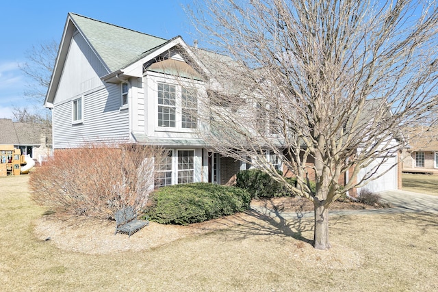 view of front of home with a garage and roof with shingles