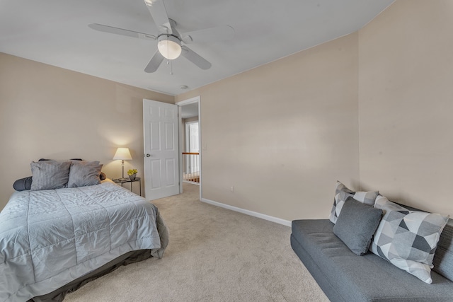 bedroom with light colored carpet, a ceiling fan, and baseboards