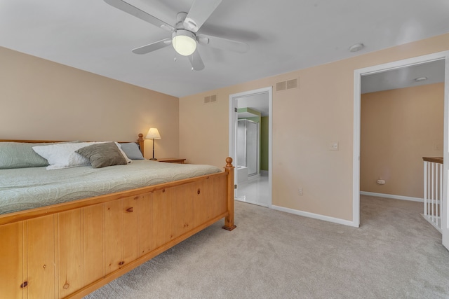 bedroom with visible vents, baseboards, light colored carpet, and ceiling fan