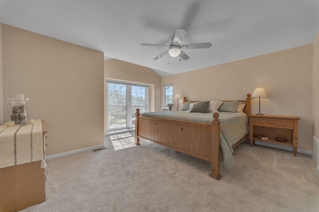 bedroom featuring light carpet, visible vents, baseboards, and lofted ceiling