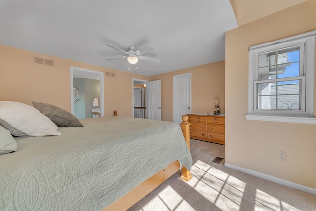 bedroom featuring light colored carpet, visible vents, and baseboards