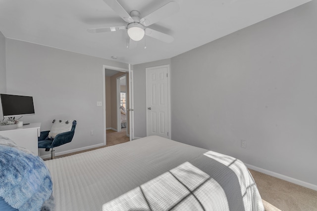 carpeted bedroom featuring baseboards and ceiling fan