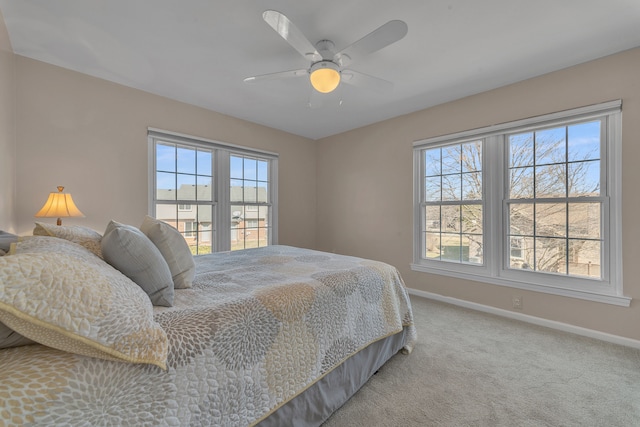 bedroom featuring baseboards, a ceiling fan, and carpet flooring