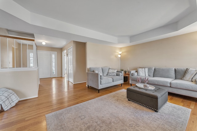 living room featuring wood finished floors and baseboards