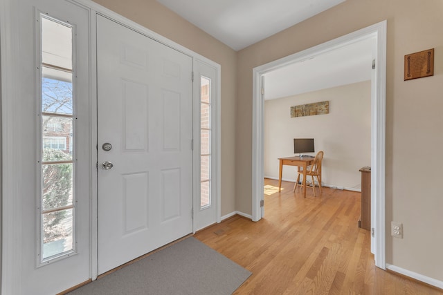 entryway featuring baseboards and light wood finished floors