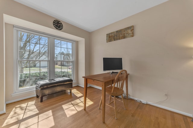 office area with baseboards and light wood-style flooring