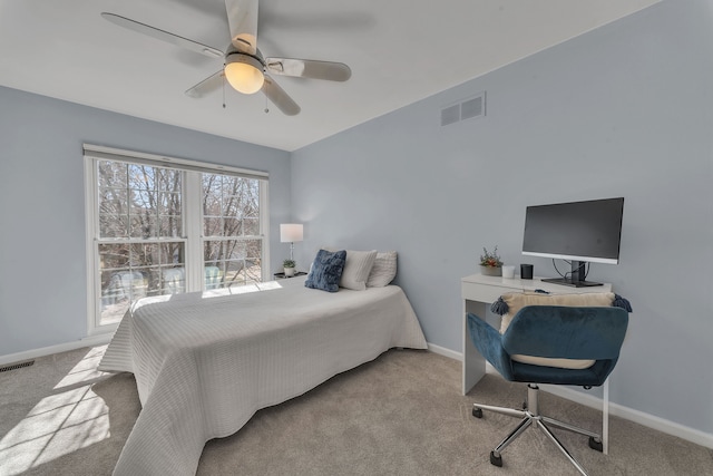 carpeted bedroom with visible vents, baseboards, and ceiling fan