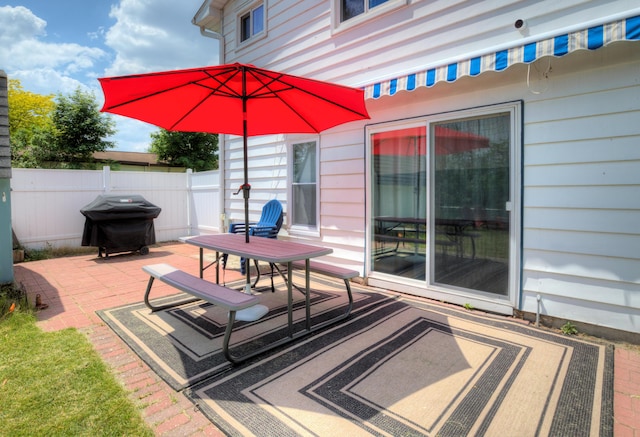 view of patio featuring fence and area for grilling